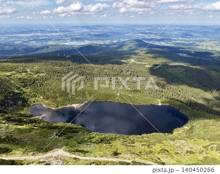 Mountain tarn and surrounding alpine landscape from high viewpoint Mountain tarn and surrounding alpine landscape from high viewpoint 140450266