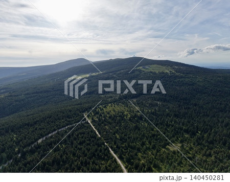 Aerial view of forested mountain ridgeline with winding trail Aerial view of forested mountain ridgeline with winding trail 140450281