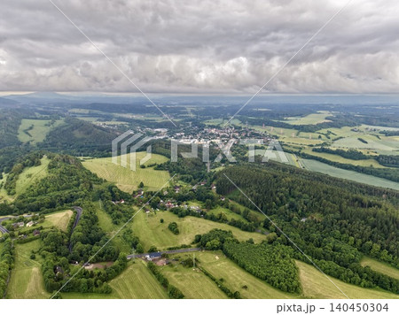 Aerial view of rolling countryside with village and stormy sky Aerial view of rolling countryside with village and stormy sky 140450304