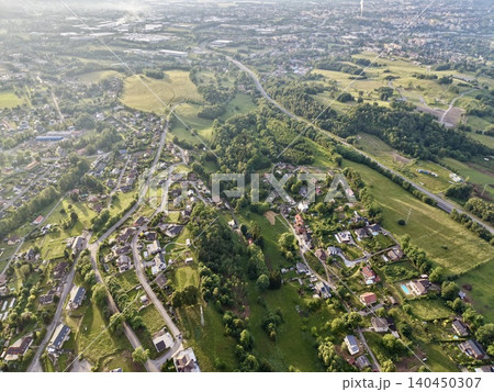 Aerial view of suburban neighborhood and rolling green countryside 140450307