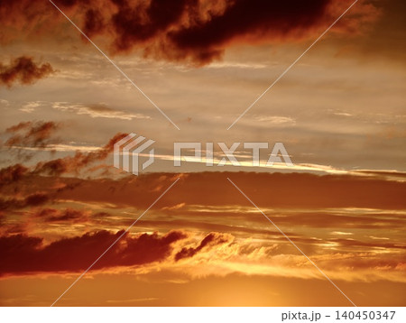 Dramatic golden sunset sky with layered clouds Dramatic golden sunset sky with layered clouds 140450347