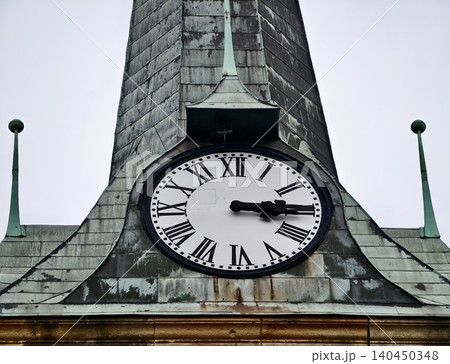 Antique clock face on weathered copper steeple with Roman numerals Antique clock face on weathered copper steeple with Roman numerals 140450348