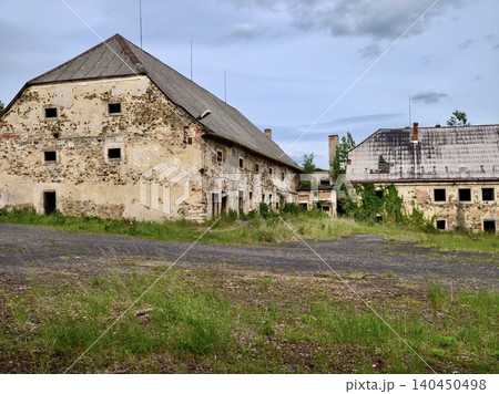 Abandoned rural farm buildings under a cloudy sky 140450498
