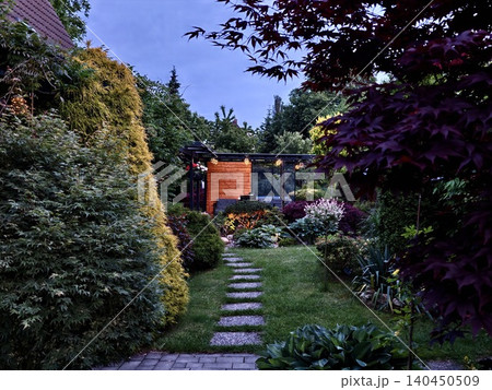 Landscaped garden path leading to a modern backyard retreat 140450509