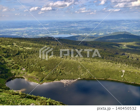Panoramic mountain landscape with lake and distant valley Panoramic mountain landscape with lake and distant valley 140450532