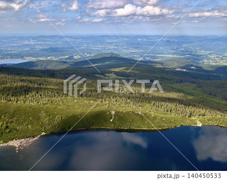 Panoramic mountain landscape with lake and distant valleys Panoramic mountain landscape with lake and distant valleys 140450533