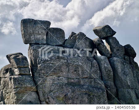 Weathered granite rock formations beneath a cloudy sky Weathered granite rock formations beneath a cloudy sky 140450536