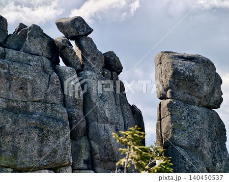 Weathered rock formations under a cloudy sky Weathered rock formations under a cloudy sky 140450537
