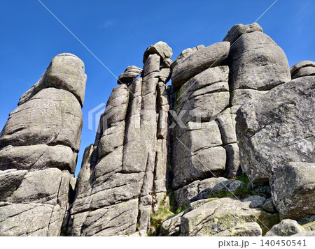 Towering granite rock formations beneath a clear blue sky Towering granite rock formations beneath a clear blue sky 140450541