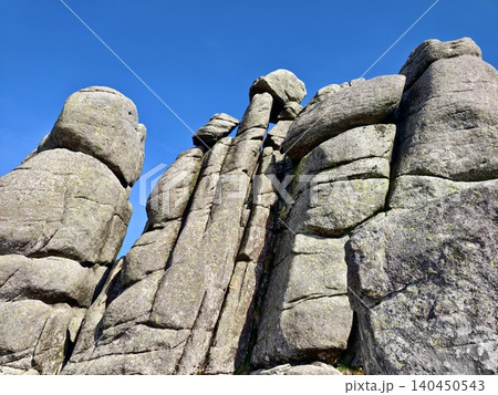 Towering granite rock formations against a clear blue sky Towering granite rock formations against a clear blue sky 140450543
