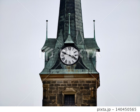 Historic clock tower with weathered copper spire Historic clock tower with weathered copper spire 140450565