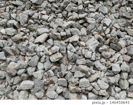 Loose crushed gray gravel piled outdoors 140450645