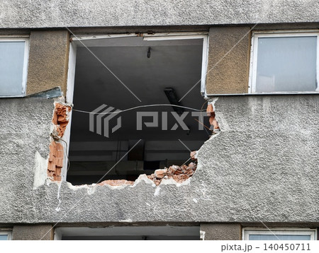Large rectangular hole in concrete building facade revealing interior ceiling Large rectangular hole in concrete building facade revealing interior ceiling 140450711
