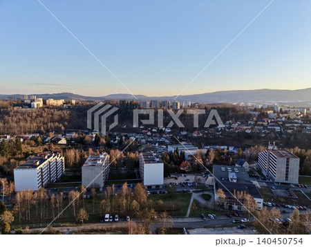 Peaceful Suburban Housing Complexes Illuminated By Gentle Evening Light With Surrounding Nature Peaceful Suburban Housing Complexes Illuminated By Gentle Evening Light With Surrounding Nature 140450754