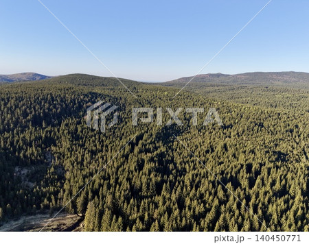 Expansive Green Landscape. Immense Lush Forest Blanketing Towering Mountains Stretching Into Sky Expansive Green Landscape. Immense Lush Forest Blanketing Towering Mountains Stretching Into Sky 140450771