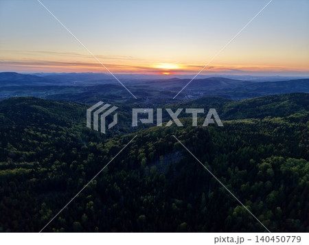 Evening Horizon With Silhouette. Silhouettes And Warm Tones Paint Tranquil Valley Scene At Sunset Evening Horizon With Silhouette. Silhouettes And Warm Tones Paint Tranquil Valley Scene At Sunset 140450779
