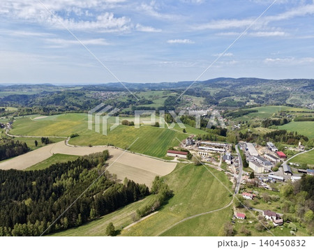 High Vantage Point Capturing Town Outskirt Merging Into Fields With Infrastructure And Mountain Ridges High Vantage Point Capturing Town Outskirt Merging Into Fields With Infrastructure And Mountain Ridges 140450832