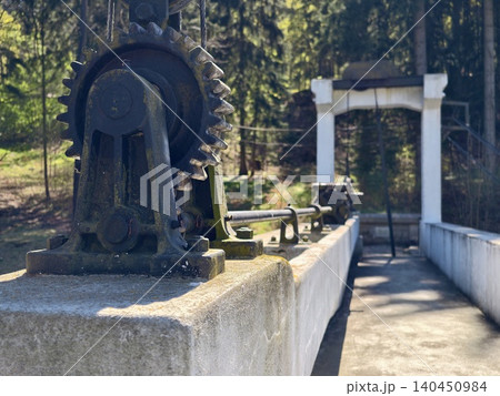 Close Examination Of Weathered Industrial Machinery Set Against Heritage And River Environment Close Examination Of Weathered Industrial Machinery Set Against Heritage And River Environment 140450984