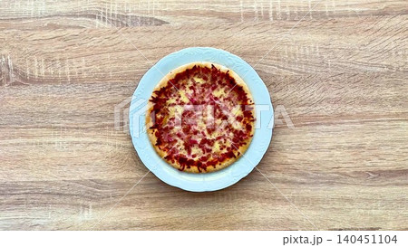 A Delicious and Flavorful Pizza with Various Toppings Served Beautifully on a Plate A Delicious and Flavorful Pizza with Various Toppings Served Beautifully on a Plate 140451104