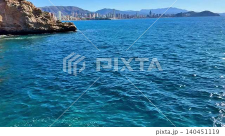 A stunning scenic coastal view showcasing clear blue waters under a radiant sky A stunning scenic coastal view showcasing clear blue waters under a radiant sky 140451119