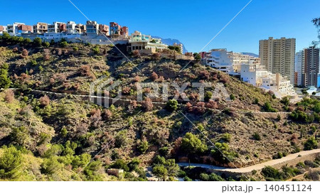 Experience a breathtaking coastal view that beautifully juxtaposes modern buildings with nature Experience a breathtaking coastal view that beautifully juxtaposes modern buildings with nature 140451124