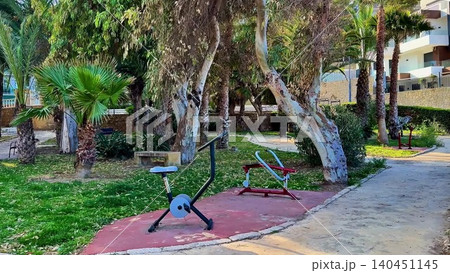 Engaging Outdoor Gym Equipment Set in a Beautiful Tropical Park Environment for Everyone Engaging Outdoor Gym Equipment Set in a Beautiful Tropical Park Environment for Everyone 140451145