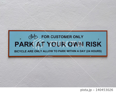 Customer parking sign with bicycle restrictions and risk disclaimer Customer parking sign with bicycle restrictions and risk disclaimer 140453026