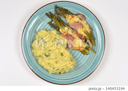 Baked asparagus with ham and mashed potatoes on plate Baked asparagus with ham and mashed potatoes on plate 140453194