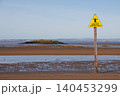 Yellow sinking mud warning sign on Weston-super-Mare beach at low tide 140453299