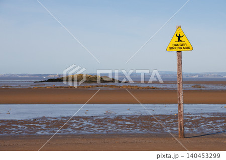 Yellow sinking mud warning sign on Weston-super-Mare beach at low tide Yellow sinking mud warning sign on Weston-super-Mare beach at low tide 140453299