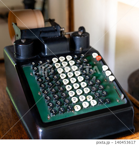 Vintage receipt printer machine, Old number typewriter on the desk 140453617