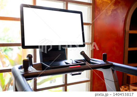 Blank white monitor screen on treadmill console. Indoor running machine for cardio workout in gym 140453817