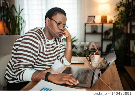 Frustrated young adult woman working from home feeling bored 140453891