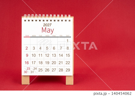 Blank desk calendar for May 2027 on red background. 140454062