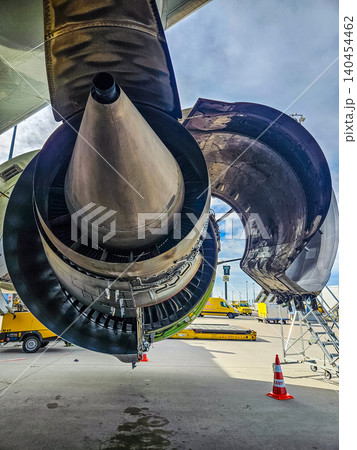 Detailed view of an airplane turbine exhaust and nacelle doors open for service. High-quality industrial photography for aerospace and engineering.. High quality photo Detailed view of an airplane turbine exhaust and nacelle doors open for service. High-quality industrial photography for aerospace and engineering.. High quality photo 140454462