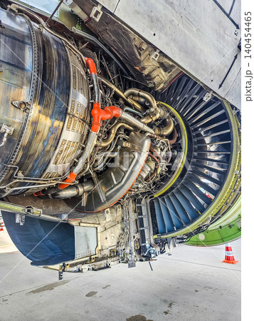 Detailed view of jet engine hardware, pipes, and wiring with open nacelle doors. Professional aerospace engineering and aviation maintenance photo.. High quality photo 140454465