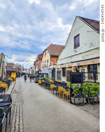 European old town street with cafes outdoor seating colorful houses and pedestrians travel city architecture lifestyle scene European old town street with cafes outdoor seating colorful houses and pedestrians travel city architecture lifestyle scene 140454545