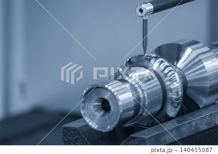 Operation of a precision surface roughness measuring machine inspecting a metal shaft part in a blue tone scene. Operation of a precision surface roughness measuring machine inspecting a metal shaft part in a blue tone scene. 140455087