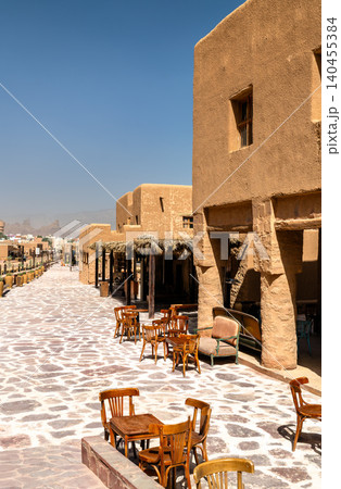 Traditional adobe architecture and outdoor seating along the stone paved street of AlUla Old Town in Saudi Arabia Traditional adobe architecture and outdoor seating along the stone paved street of AlUla Old Town in Saudi Arabia 140455384