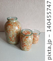 Homemade fermented sauerkraut, crunchy pickled cabbage and carrots in glass jars promoting healthy eating, probiotic food, and a traditional preserving method 140455747