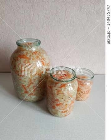 Homemade fermented sauerkraut, crunchy pickled cabbage and carrots in glass jars promoting healthy eating, probiotic food, and a traditional preserving method Homemade fermented sauerkraut, crunchy pickled cabbage and carrots in glass jars promoting healthy eating, probiotic food, and a traditional preserving method 140455747