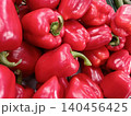 Red bell peppers are filling a frame, showing their smooth, glossy skin and vibrant color, representing fresh vegetables, healthy eating, and organic food choices 140456425