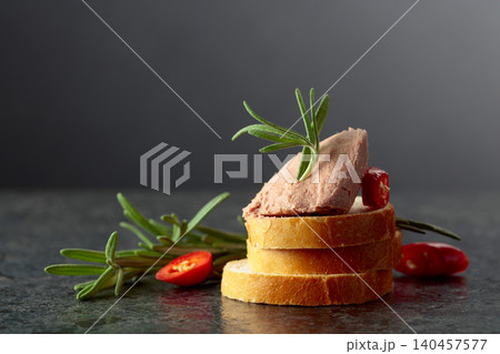 Bread slices with pate, red pepper, and rosemary. Bread slices with pate, red pepper, and rosemary. 140457577