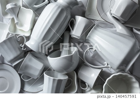 Various white ceramic kitchenware on white fabric. 140457591