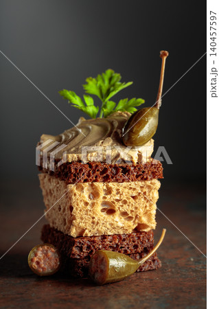 Bread with pate, capers, and fresh parsley. 140457597
