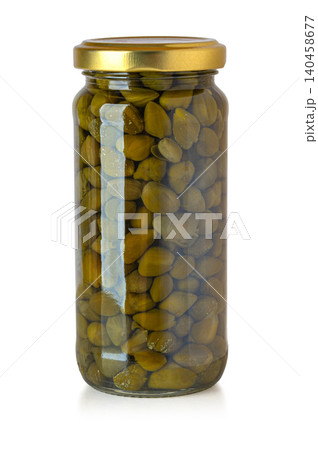 Capers in glass jar on white background Capers in glass jar on white background 140458677