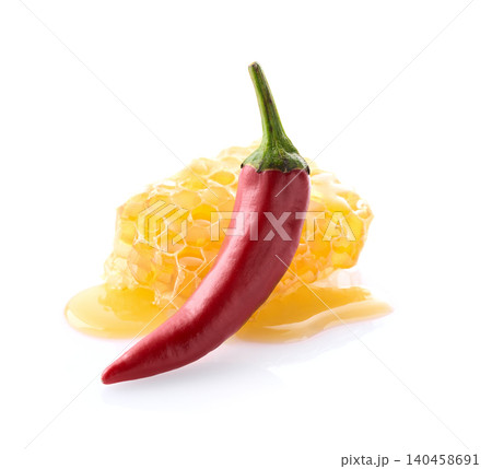 Honeycomb and hot red pepper on white background Honeycomb and hot red pepper on white background 140458691