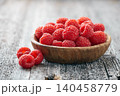 Raspberry closeup on wooden background 140458779