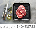 Beefsteak with spices and grill skillet on stone background 140458782