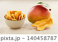 Mango slices dehydrated in closeup in beige background 140458787